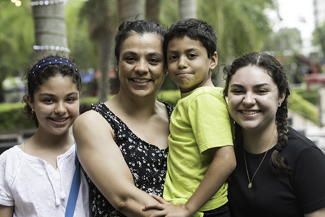 Hispanic woman with her children Smiling Hispanic mature woman posing with her children